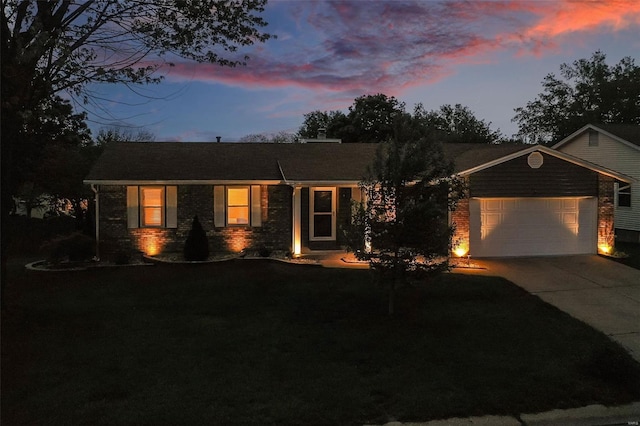 ranch-style house featuring an attached garage, concrete driveway, and brick siding