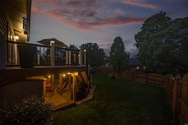view of yard with a wooden deck and a fenced backyard