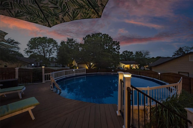 view of swimming pool featuring a fenced in pool, a wooden deck, and a fenced backyard
