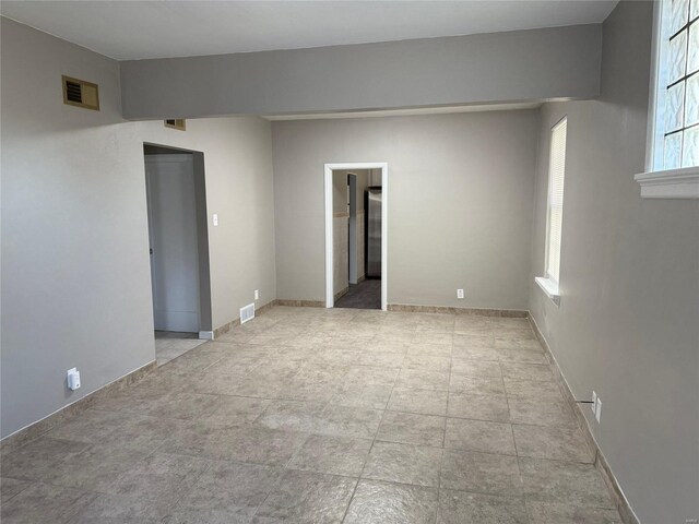 spare room featuring visible vents