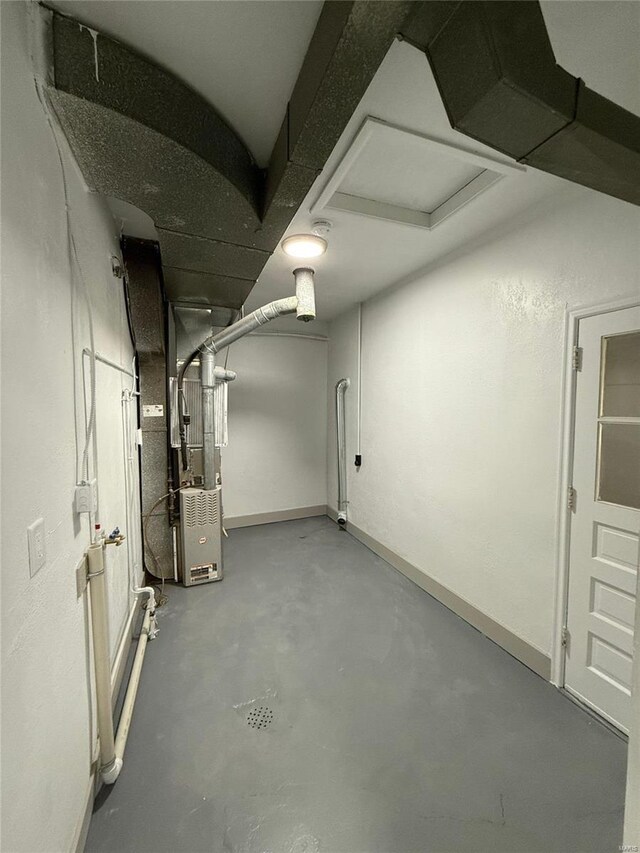 below grade area with baseboards and heating unit