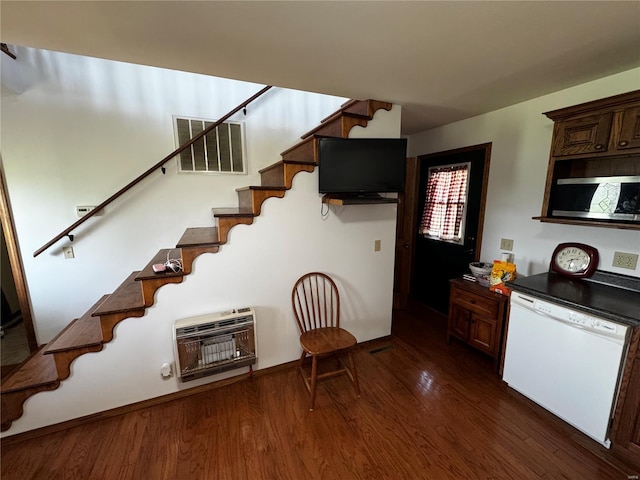 kitchen with dishwasher, stainless steel microwave, heating unit, visible vents, and dark wood-style floors
