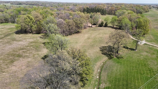 aerial view featuring a view of trees and a rural view