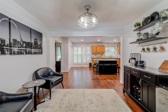 interior space with decorative backsplash and dark wood-style floors