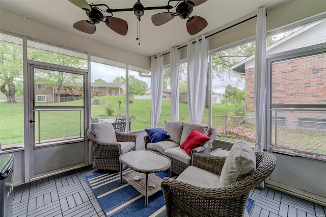 sunroom / solarium with outdoor lounge area and a ceiling fan