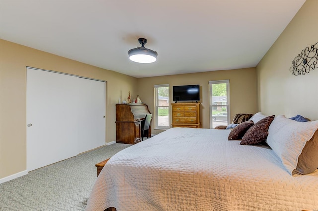 bedroom with carpet and baseboards