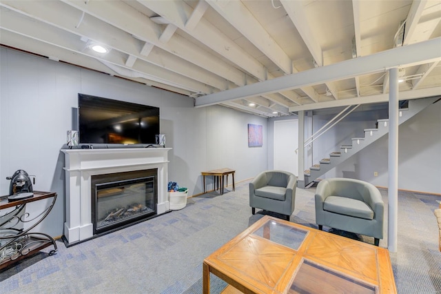 carpeted living area with stairway and a glass covered fireplace