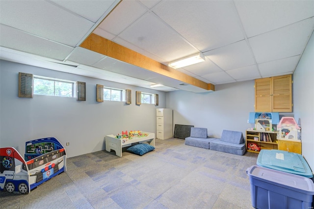 rec room with a paneled ceiling and carpet floors
