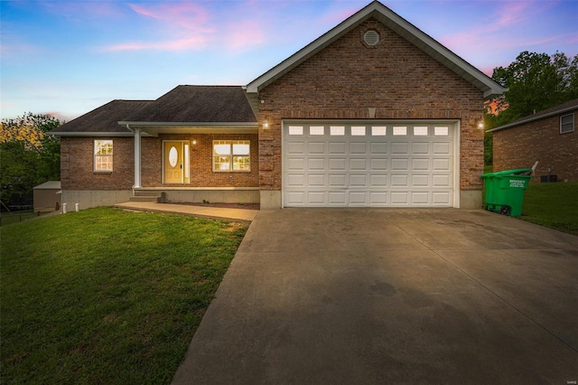 view of front of home featuring concrete driveway, a front yard, brick siding, and an attached garage