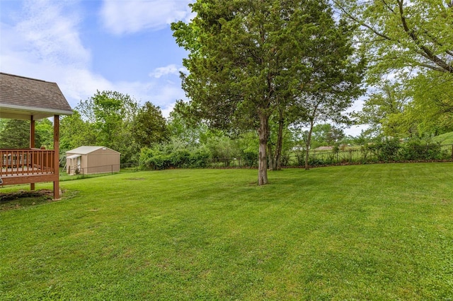 view of yard with fence and a deck