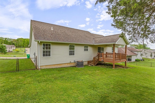 back of house featuring central air condition unit, a gate, a yard, a fenced backyard, and a wooden deck