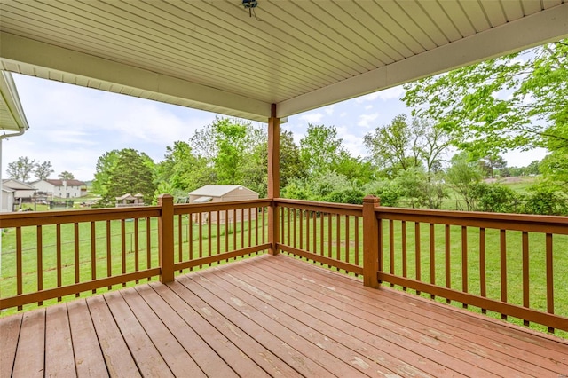 wooden deck with a lawn