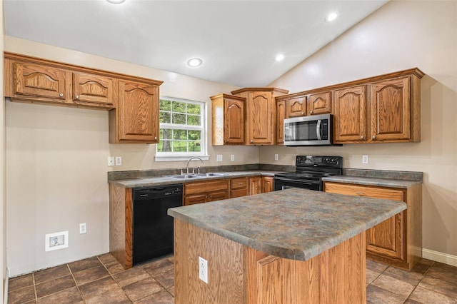 kitchen featuring black appliances, dark countertops, brown cabinets, and a sink