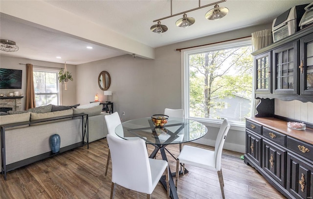 dining room featuring beamed ceiling, recessed lighting, baseboards, and wood finished floors