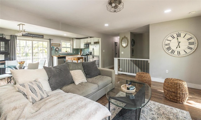 living room featuring baseboards, recessed lighting, and wood finished floors