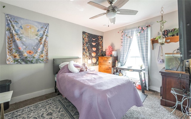 carpeted bedroom with a ceiling fan and baseboards
