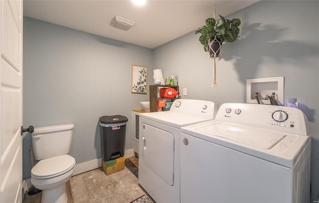 laundry area with baseboards, laundry area, independent washer and dryer, and visible vents