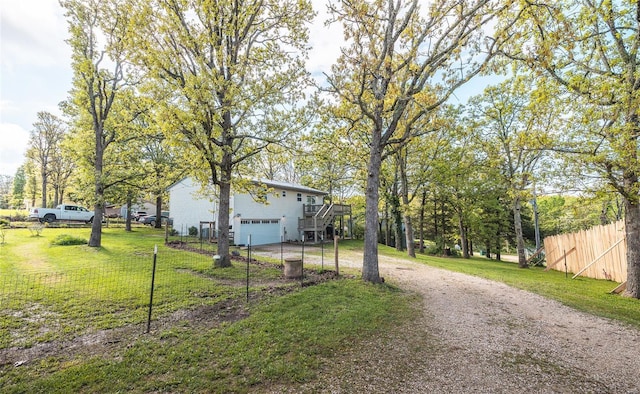 view of street featuring stairs and dirt driveway