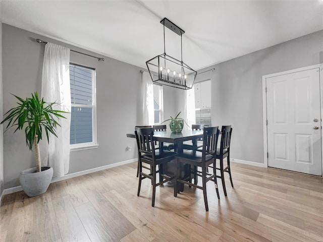 dining space with light wood-style floors and baseboards