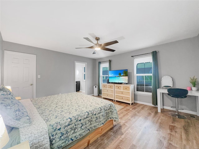 bedroom featuring baseboards, a ceiling fan, and wood finished floors