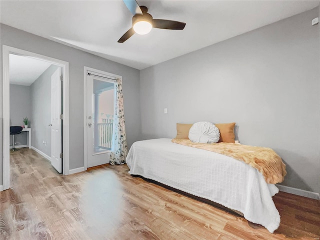 bedroom with a ceiling fan, baseboards, access to exterior, and wood finished floors