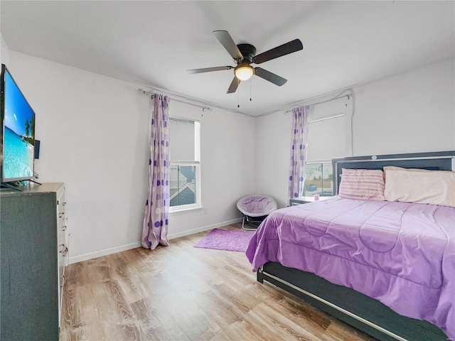 bedroom featuring baseboards, ceiling fan, and wood finished floors