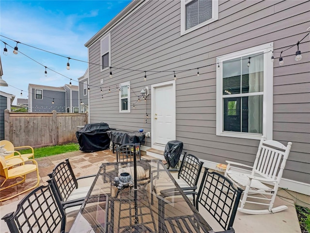 view of patio / terrace with outdoor dining area, fence, and area for grilling