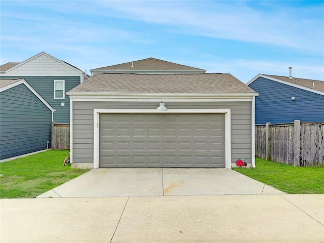 garage featuring fence and driveway