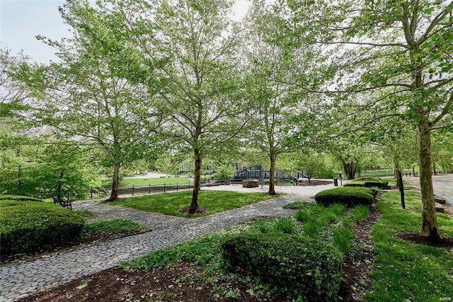 surrounding community with a lawn and fence