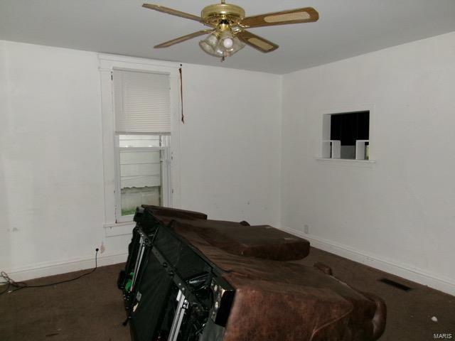 carpeted bedroom with baseboards and ceiling fan