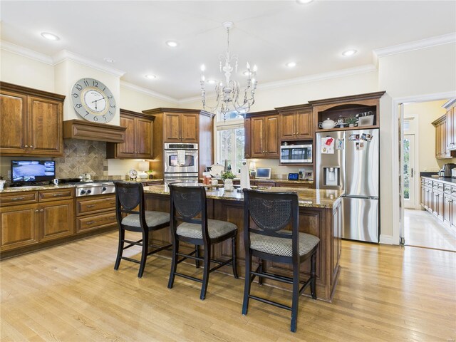 kitchen featuring light wood-style floors, a kitchen island, appliances with stainless steel finishes, open shelves, and an inviting chandelier
