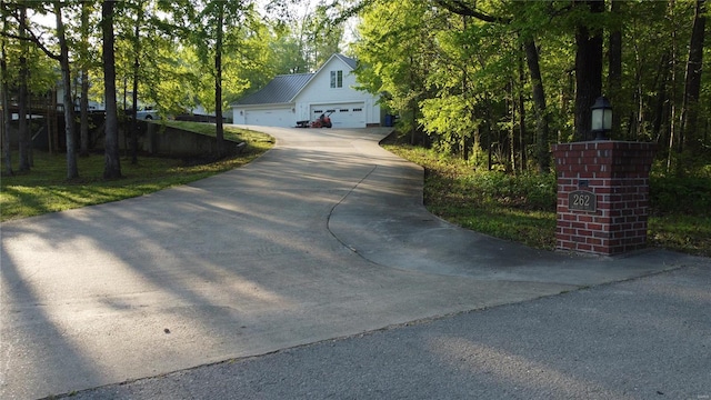 exterior space featuring driveway and metal roof