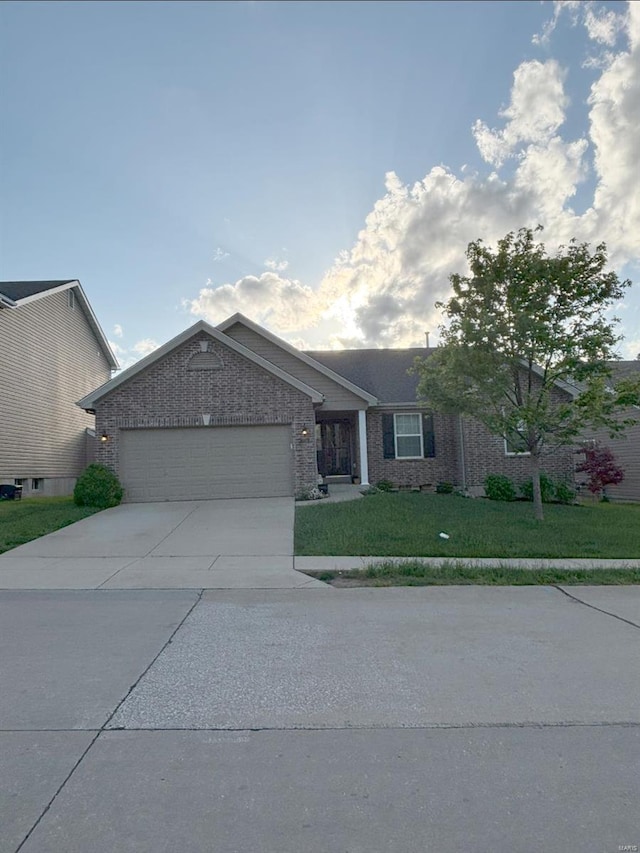 ranch-style home with an attached garage, brick siding, a front yard, and concrete driveway