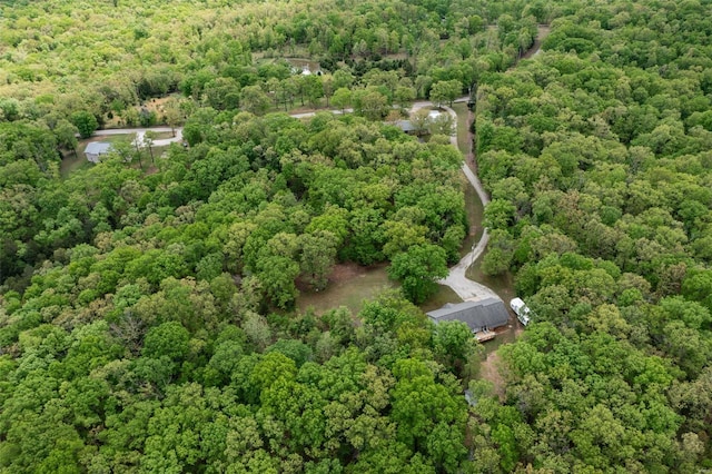 drone / aerial view featuring a wooded view