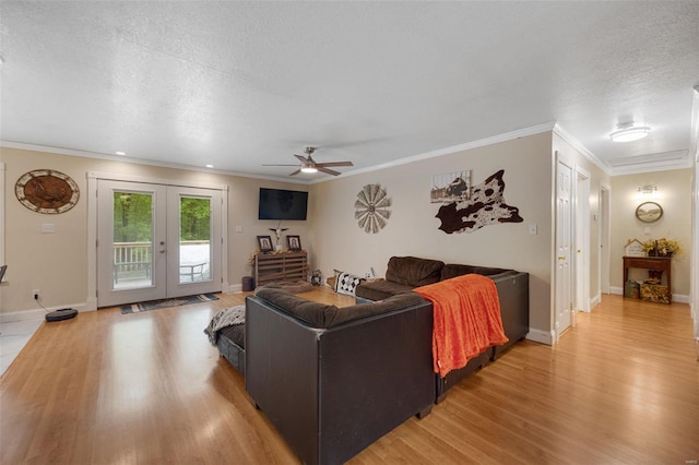 living area featuring crown molding, ceiling fan, french doors, and light wood-style floors