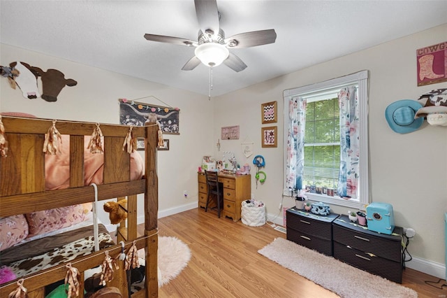 bedroom featuring baseboards, ceiling fan, and light wood-type flooring