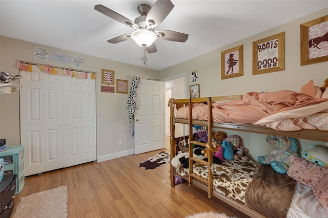 bedroom featuring a ceiling fan, baseboards, a closet, and light wood-type flooring