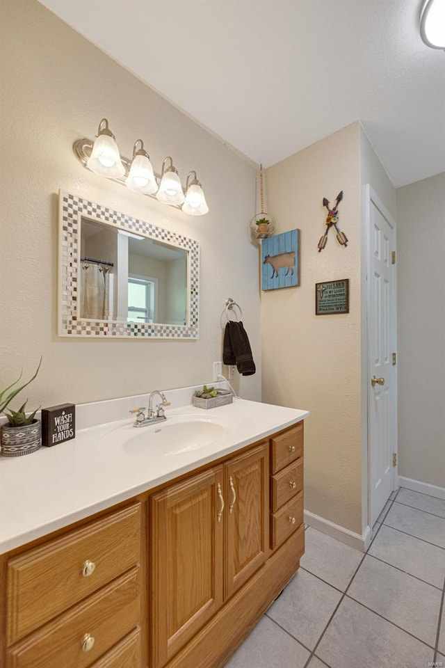 full bathroom featuring tile patterned floors, baseboards, and vanity