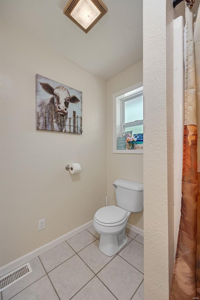 bathroom featuring baseboards, tile patterned flooring, toilet, and visible vents