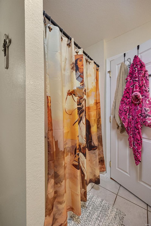 bathroom featuring tile patterned floors and a shower with curtain
