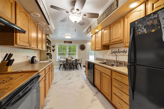 kitchen with crown molding, marble finish floor, ceiling fan, a sink, and black appliances