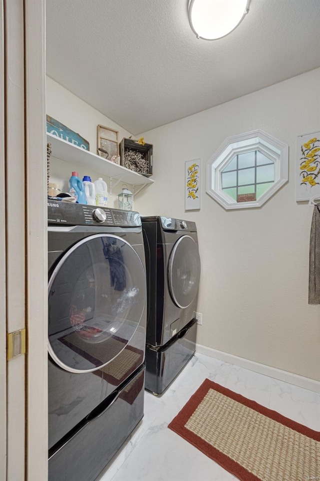 laundry room with laundry area, a textured ceiling, and independent washer and dryer