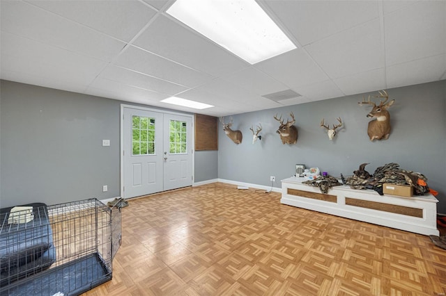 entrance foyer featuring baseboards and a drop ceiling