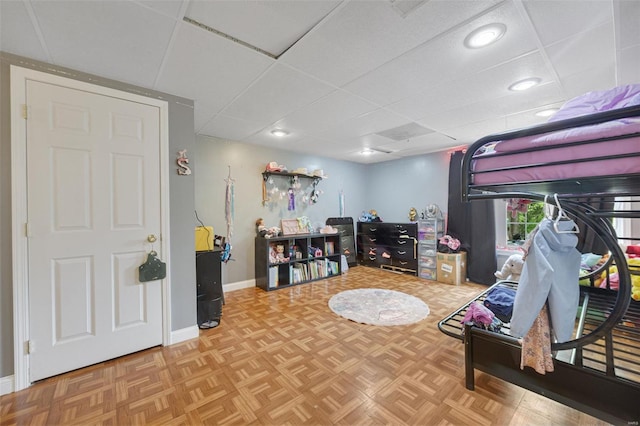 bedroom featuring recessed lighting, baseboards, and a drop ceiling