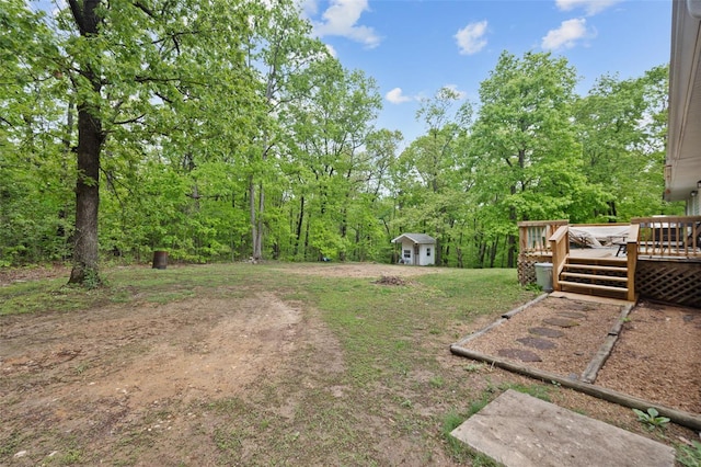 view of yard featuring an outdoor structure and a deck