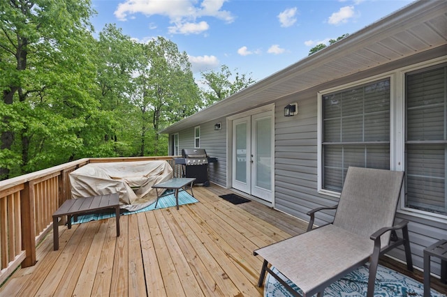 wooden terrace with area for grilling and french doors