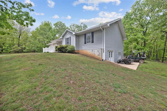 view of property exterior with a lawn