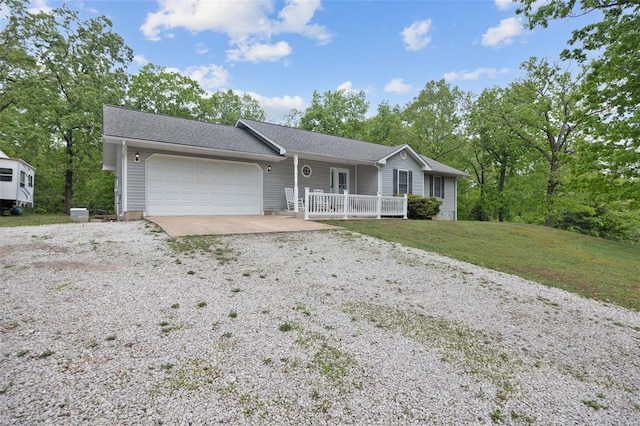 ranch-style home with a garage, a front yard, and gravel driveway