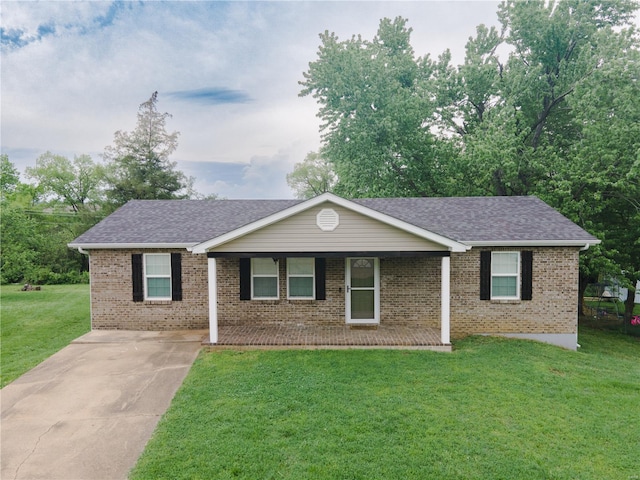 ranch-style home with a porch, brick siding, a shingled roof, and a front lawn