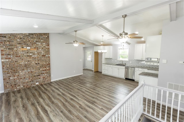 kitchen with stainless steel dishwasher, ceiling fan with notable chandelier, and wood finished floors